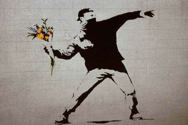 Soldier throwing flowers Banksy